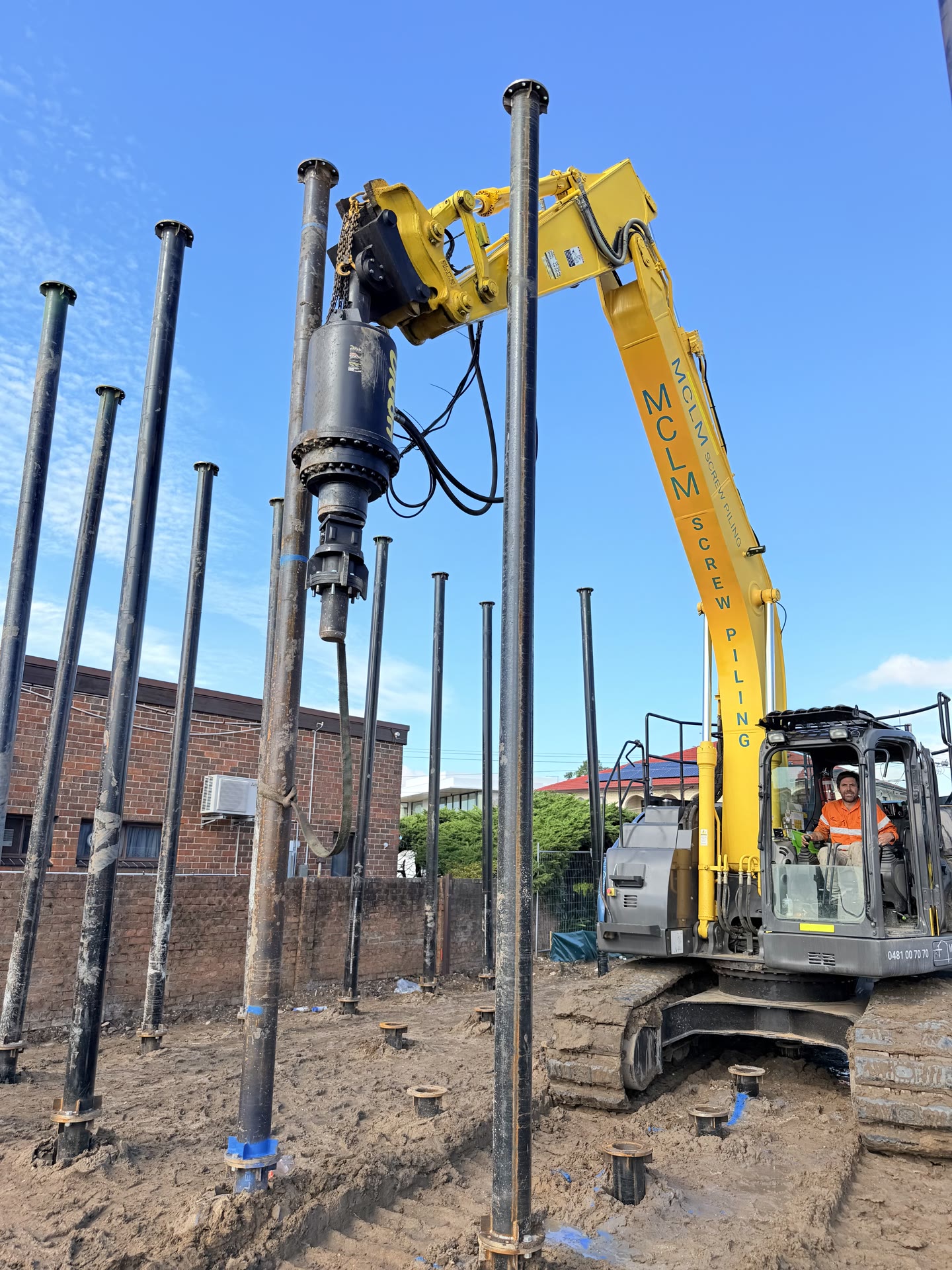 Installed steel screw piles set out across a building site ready for the structure